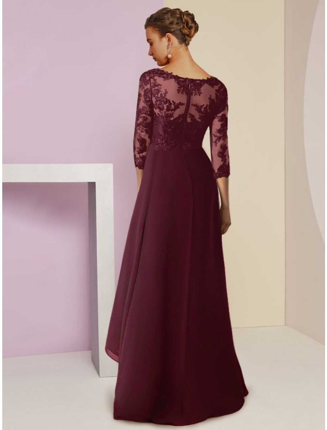 Back view of the navy A-line mother of the bride dress with ruching details.