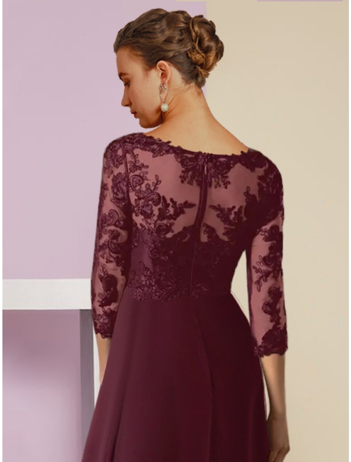 Side view of the elegant navy chiffon dress, highlighting the crystal brooch and asymmetrical hem.