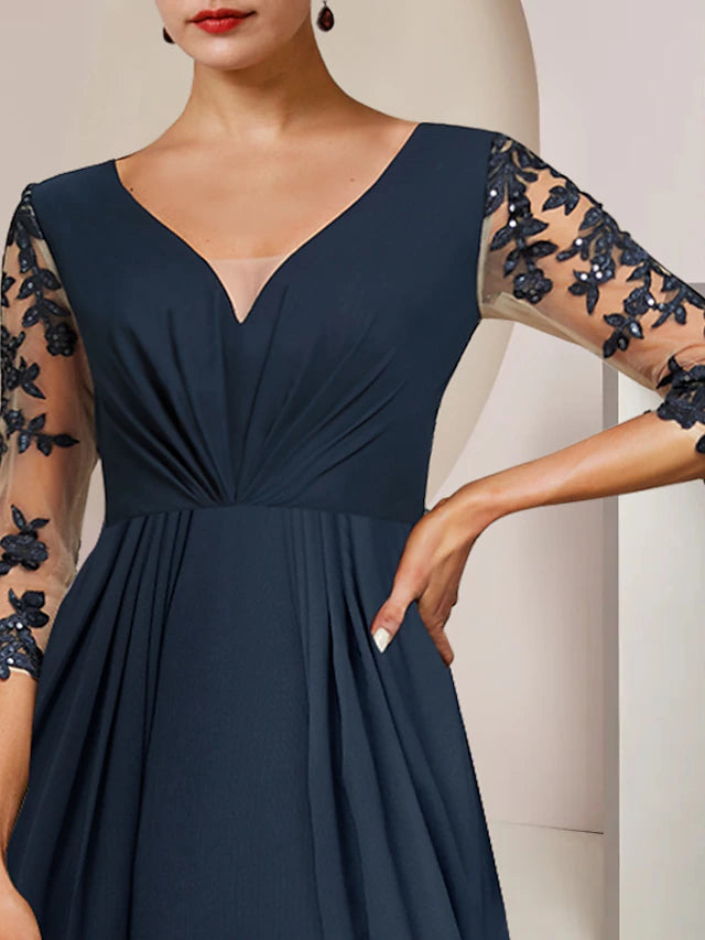 Close-up of the V-neckline and 3/4 lace sleeve with sequin details on the A-line dress.