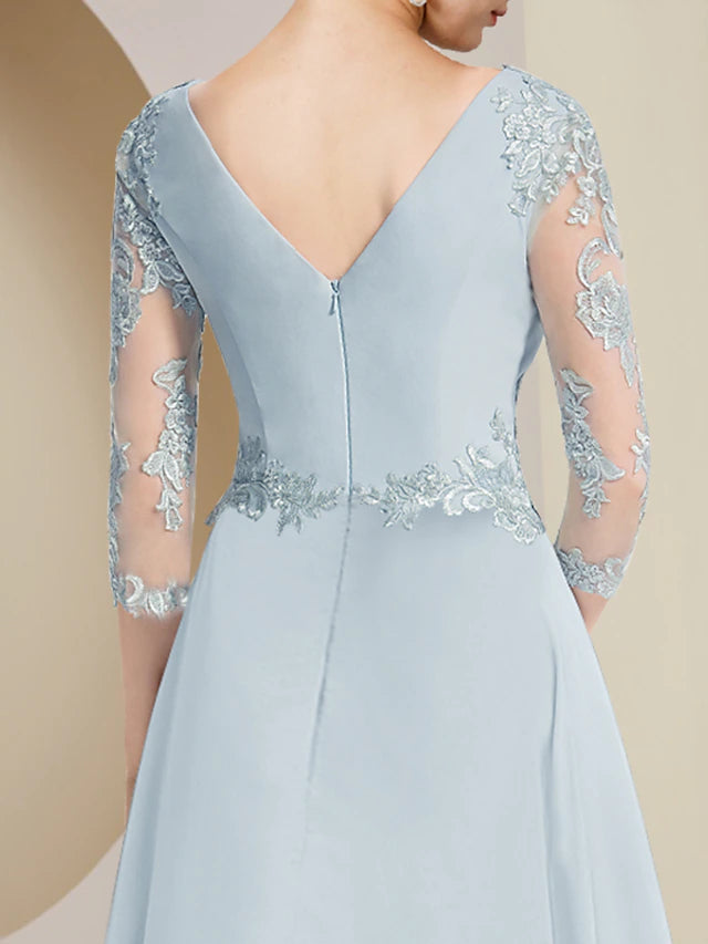 Close-up of the V-neckline and asymmetrical lace on the formal dress.