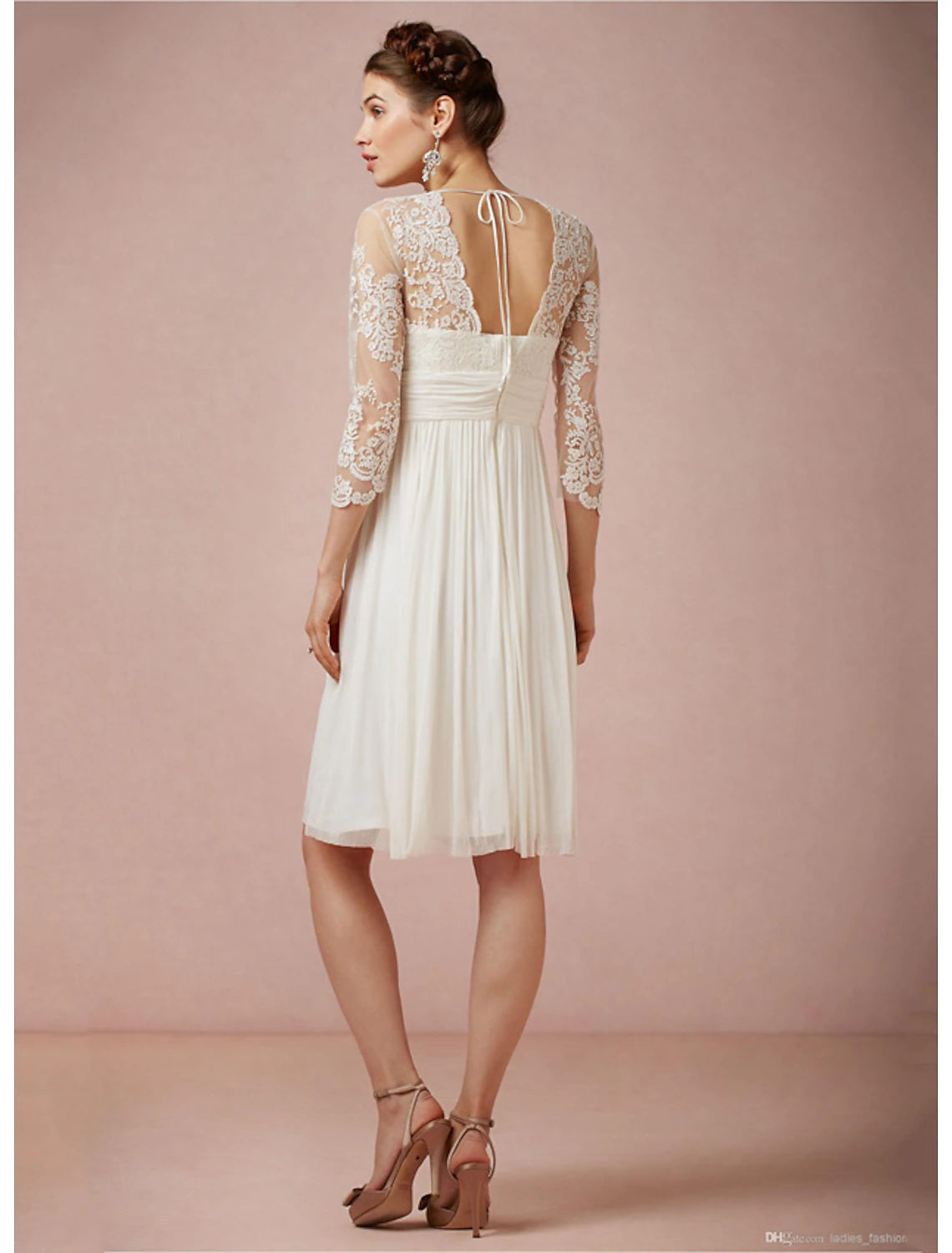 Close-up of the V-neckline and 3/4 sleeves on the white chiffon dress.