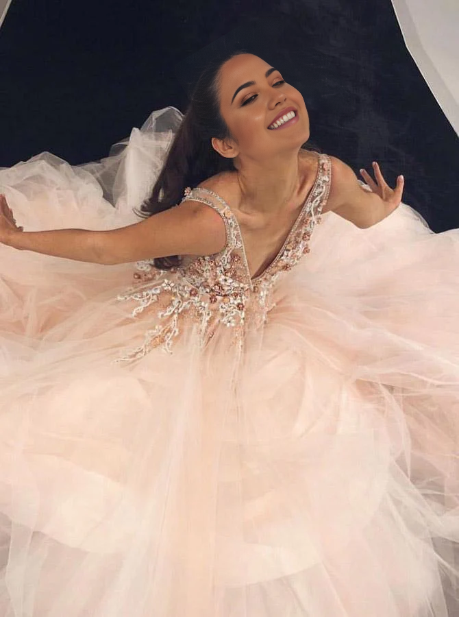 Back view of the pink A-line V-neck prom dress, showcasing its floor-length design.