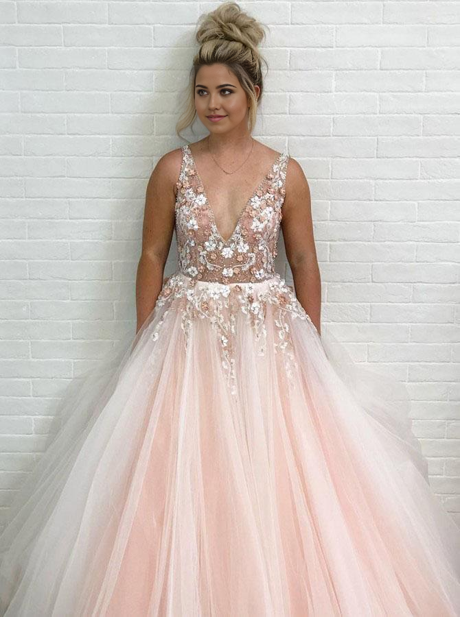 Close-up of the intricate appliques and delicate beading on the pink prom dress.