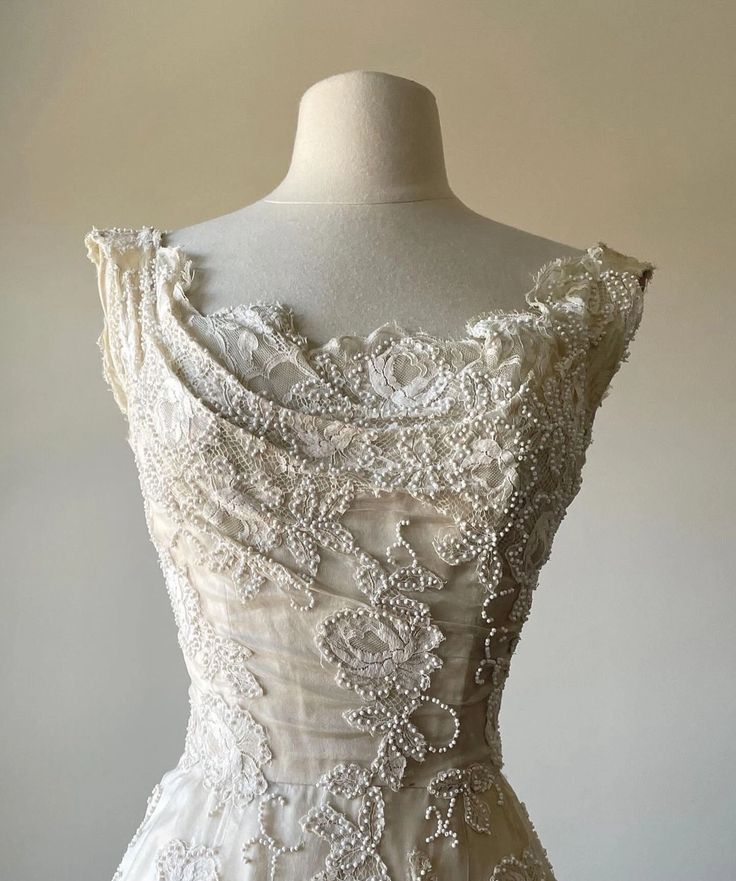 Close-up of intricate applique and beading on the bodice of the satin prom dress.