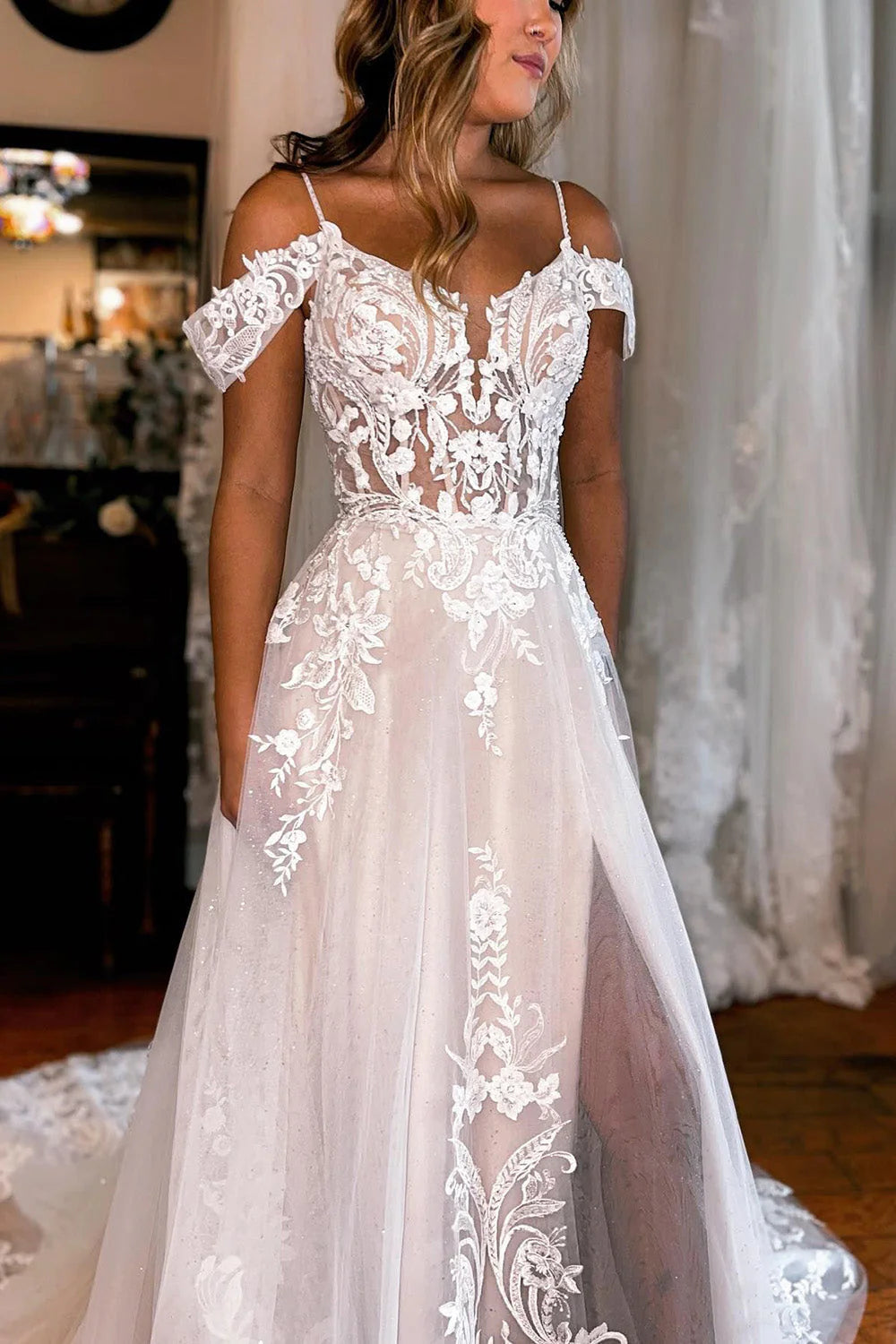 Close-up of intricate appliques on an ivory A-line wedding dress.