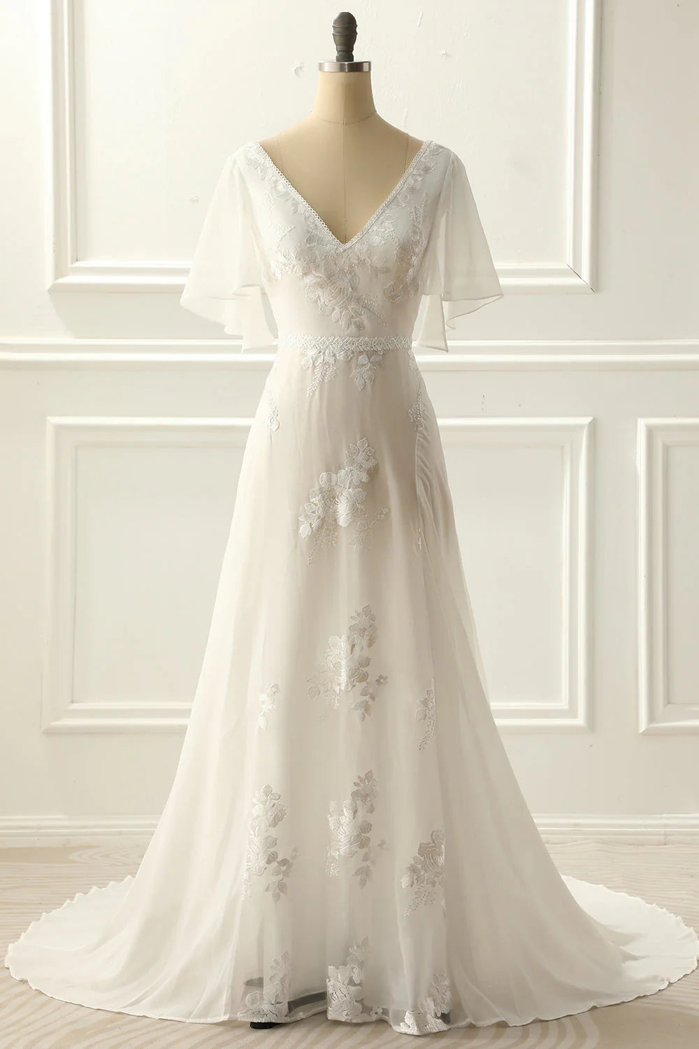 Elegant A-line V-neck ivory wedding dress with delicate appliques, front view.