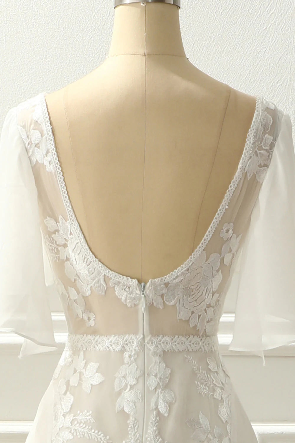 Back view of the long ivory A-line wedding dress featuring V-neck and appliques.