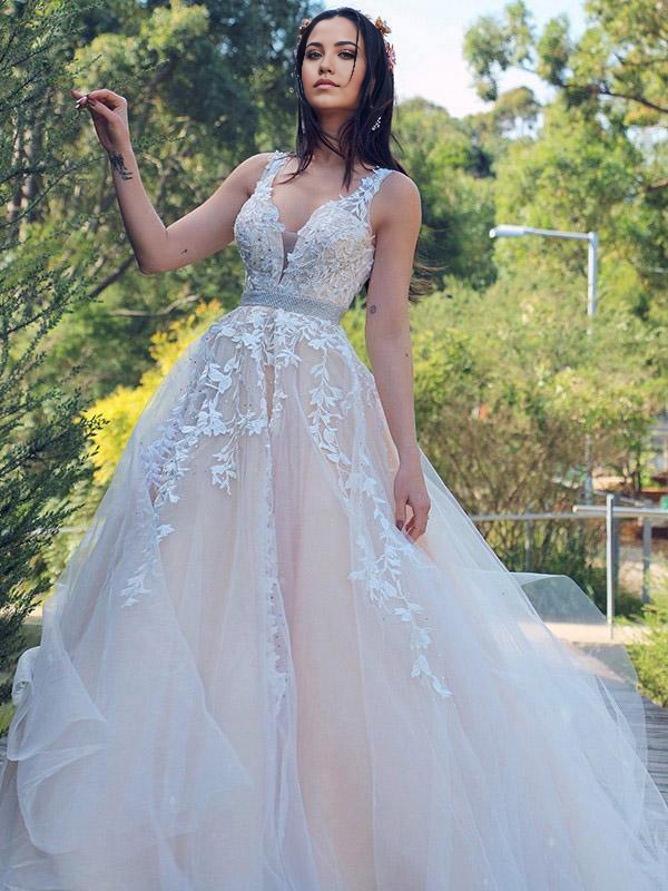 Close-up of applique detail on V-neck wedding dress.