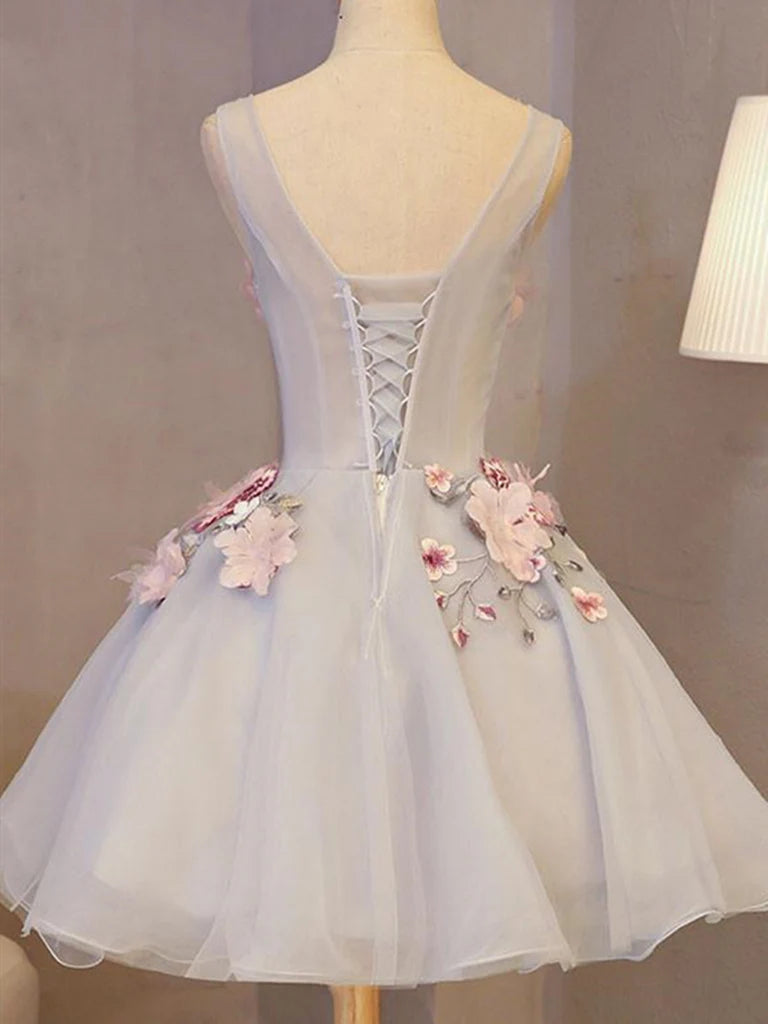 Side view of a woman wearing a sleeveless A-line V-neck short homecoming dress with floral appliques.