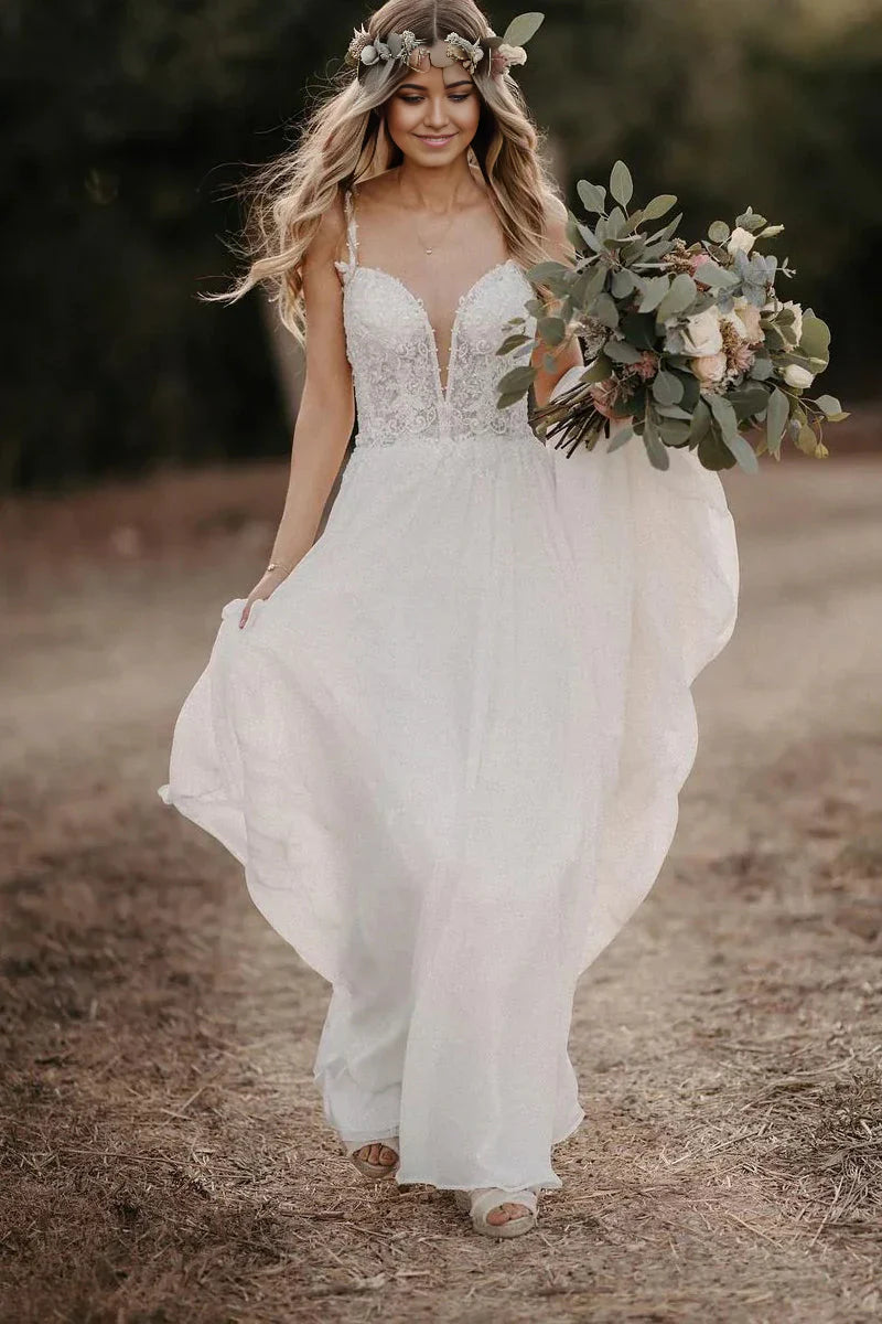 Woman wearing an elegant A-line V-neck chiffon wedding dress with appliques.