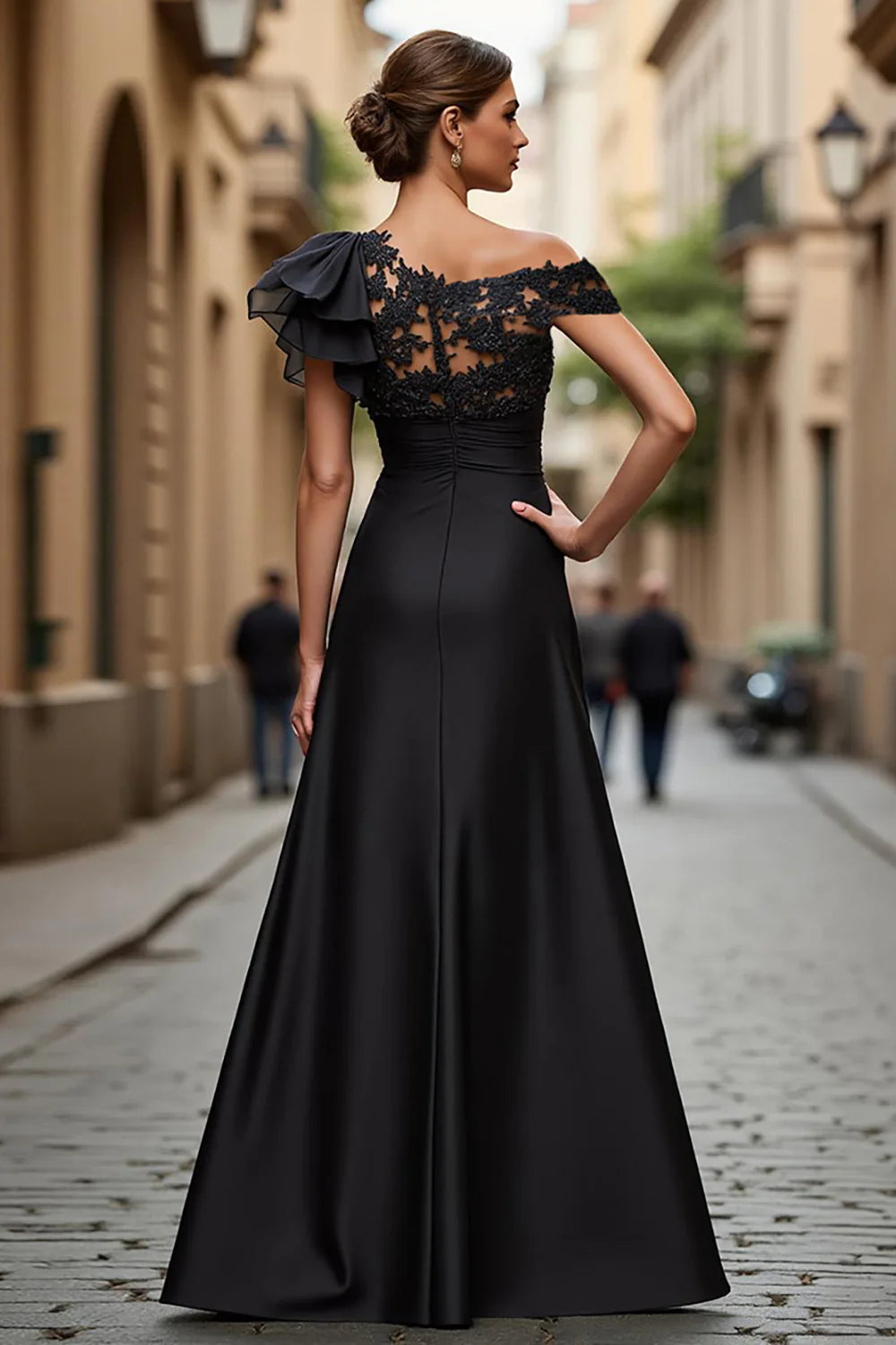 Back view of black A-line prom dress with asymmetrical hem.