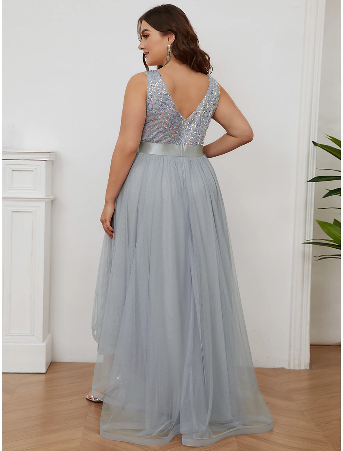 Side view of asymmetrical tiered sequined bridesmaid dress.