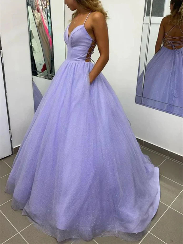 Woman wearing an elegant V-neck backless long tulle A-line prom dress.