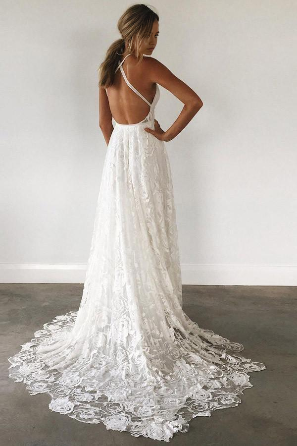 Close-up of the backless design and intricate lace details on the wedding dress.