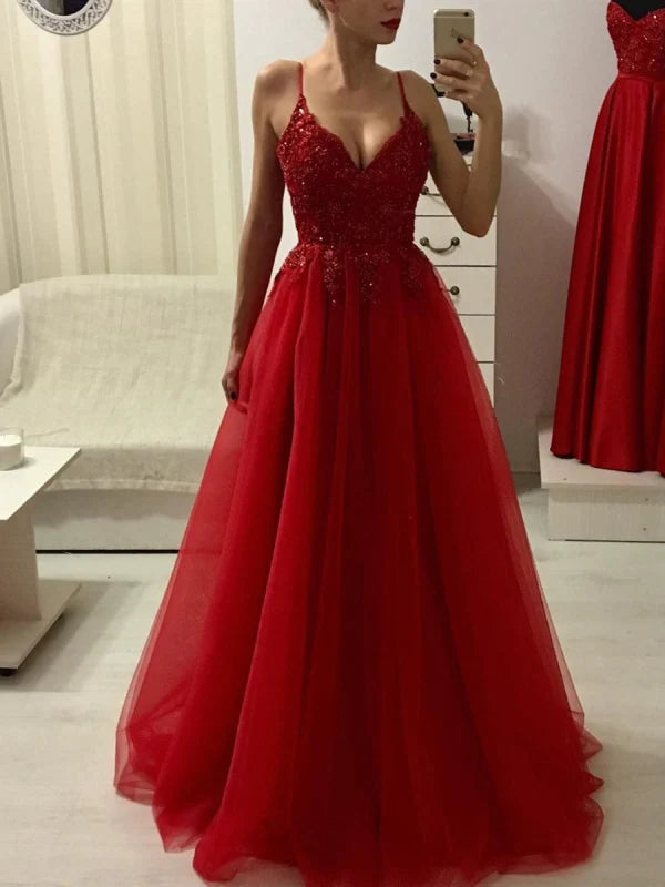 Front view of an elegant A-line V-neck prom dress with spaghetti straps, lace, and beadings.