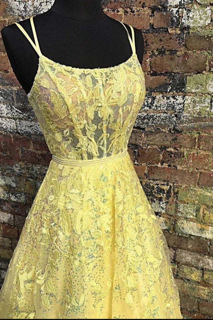 Woman wearing an elegant backless lace floral long prom dress with a V-neck.
