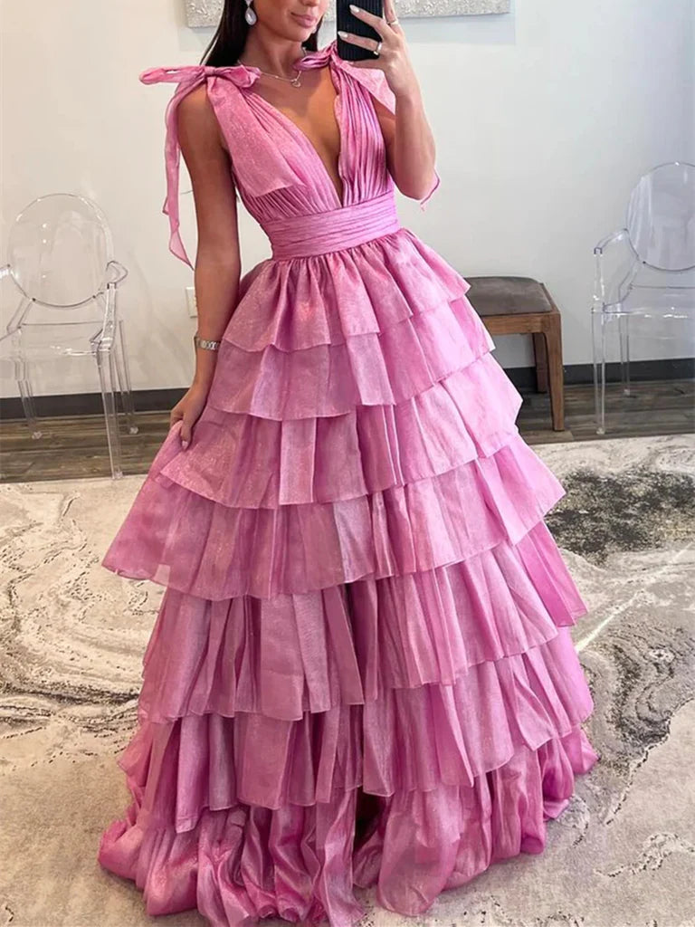 Model wearing an elegant long A-line tulle prom dress with a V-neckline.
