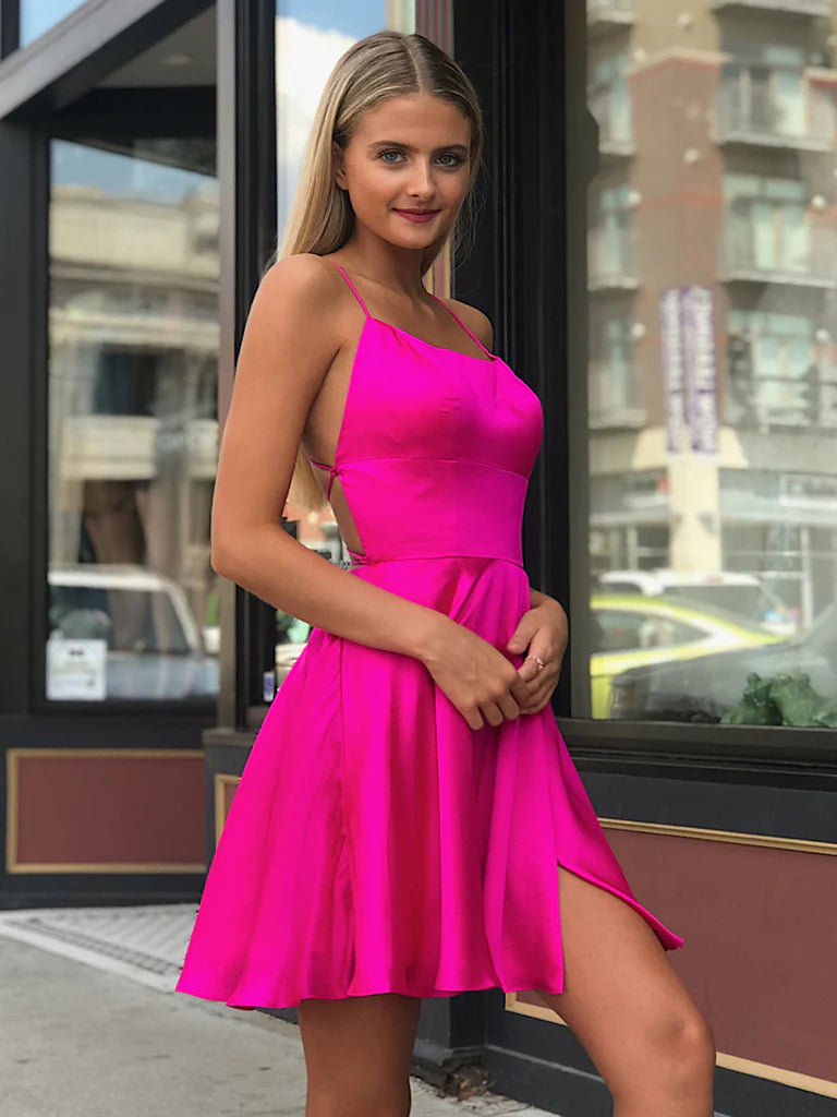 Model wearing a short pink backless A-line prom dress.