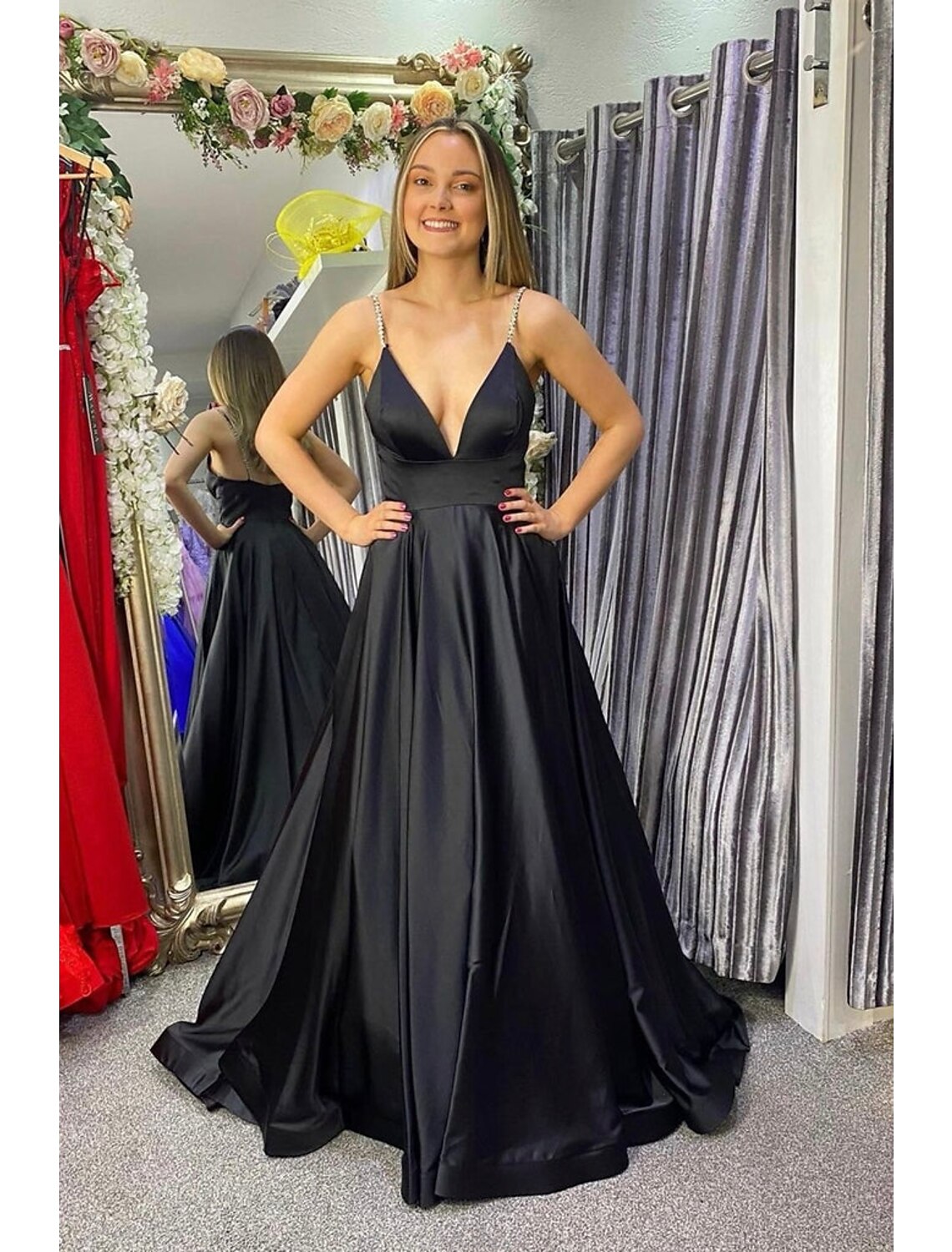 Model wearing an elegant A-Line V-Neck floor-length prom dress with a backless design and delicate pleats.