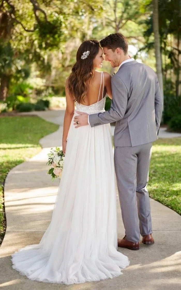 Side profile of the elegant A-line wedding gown, highlighting its flowing tulle skirt.