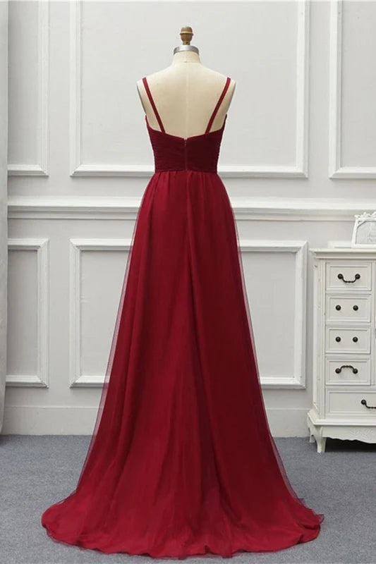 Side view of an A-line formal dress featuring a flowing tulle high-low skirt.