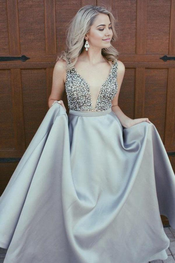 Close-up of the V-neckline and beading on the royal blue satin dress.
