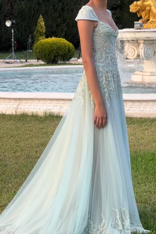Light green A-line prom dress with intricate beading.