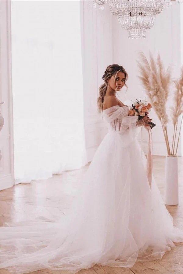 A-Line boho wedding dress with detachable long puff sleeves and V-neck.
