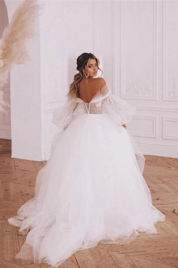 Back view of A-Line boho wedding dress with flowing skirt.