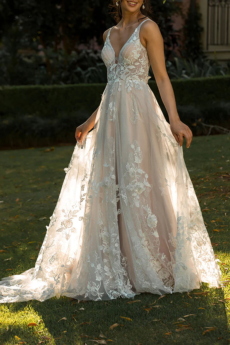 Elegant A-line V-neck boho wedding dress with lace appliques and sweep train.
