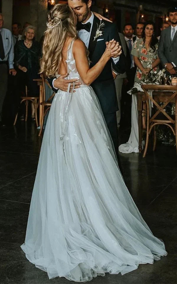 Lace and applique details on a V-neck wedding dress bodice.