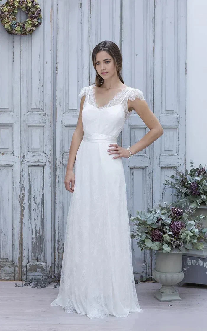 Elegant A-line V-neck wedding dress with cap sleeves and lace details.