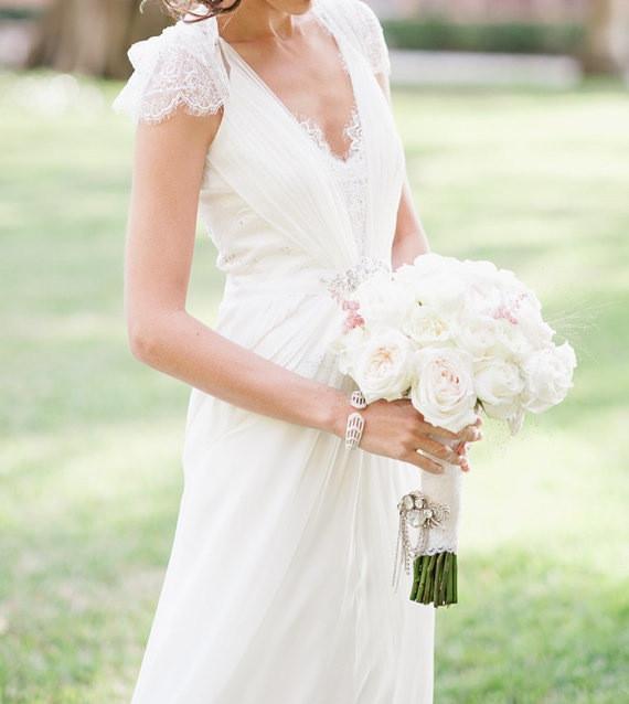 Close-up of V-neck and cap sleeves with intricate lace detail.