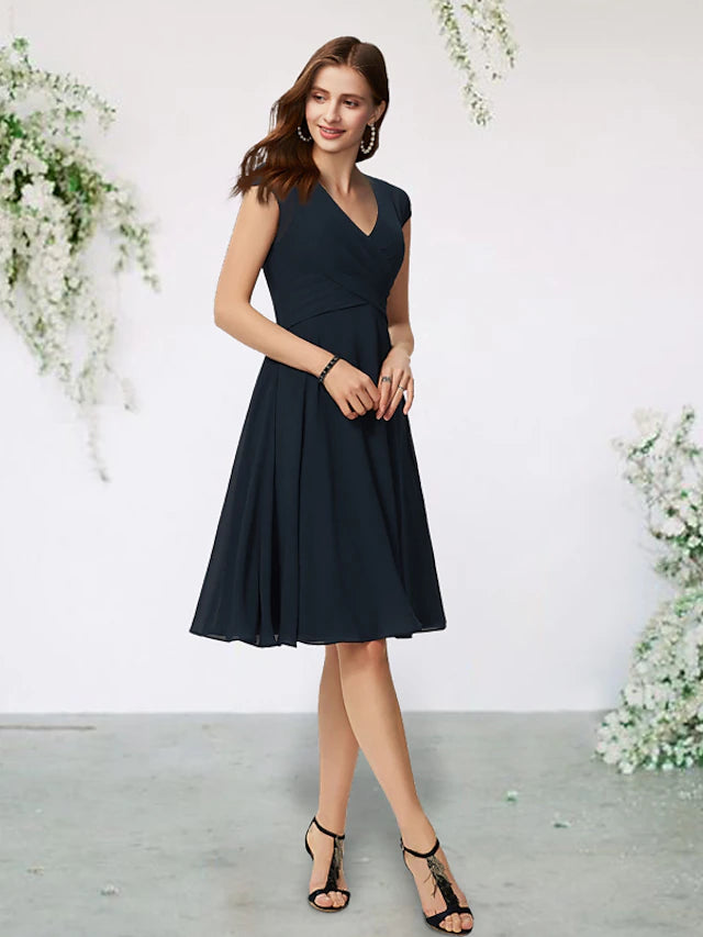 Side view of the navy A-line dress, highlighting the side-draped pleats.