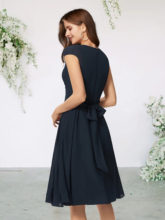 Back view of the knee-length navy chiffon Mother of the Bride dress.