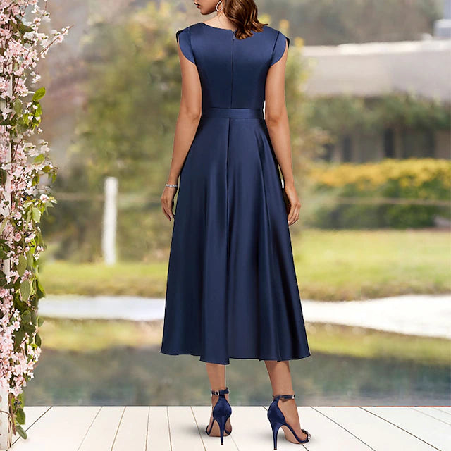 Side view of the V-neck Charmeuse dress highlighting the asymmetrical tea length.