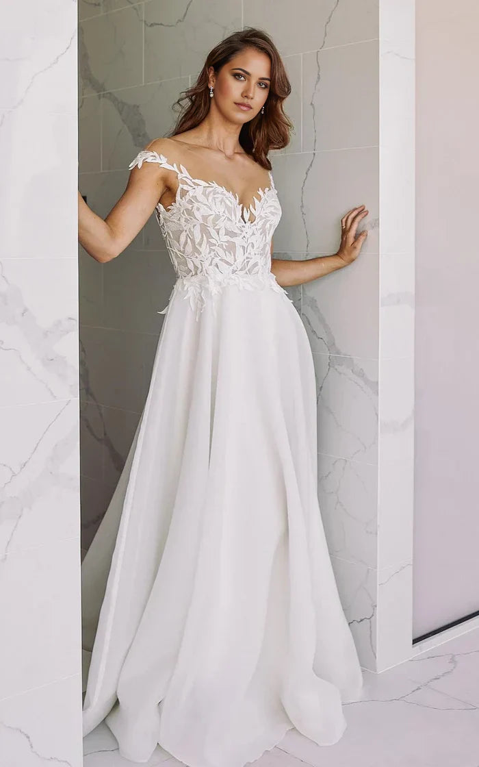Elegant A-line V-neck chiffon wedding dress with delicate appliques and a floor-length skirt.