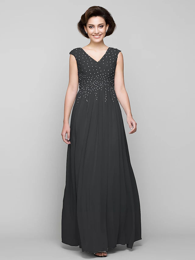 Close-up of the V-neckline and intricate beading on the dress.