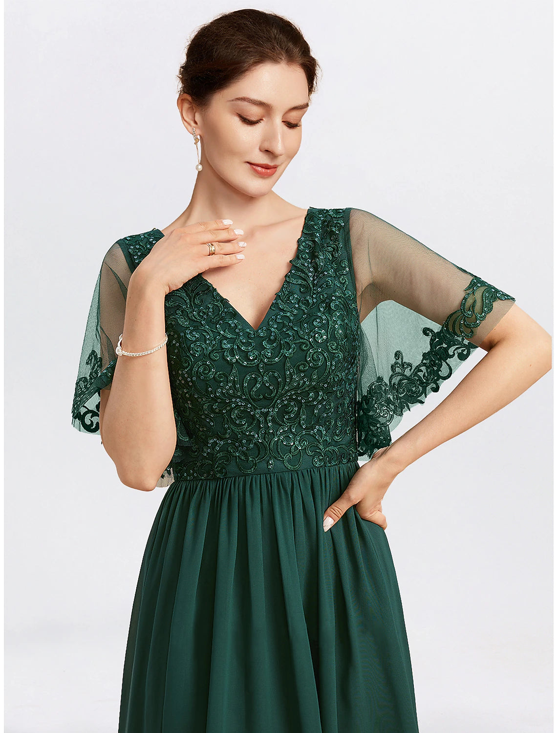 Detail of the intricate beading appliques on the V-neck chiffon cape dress.