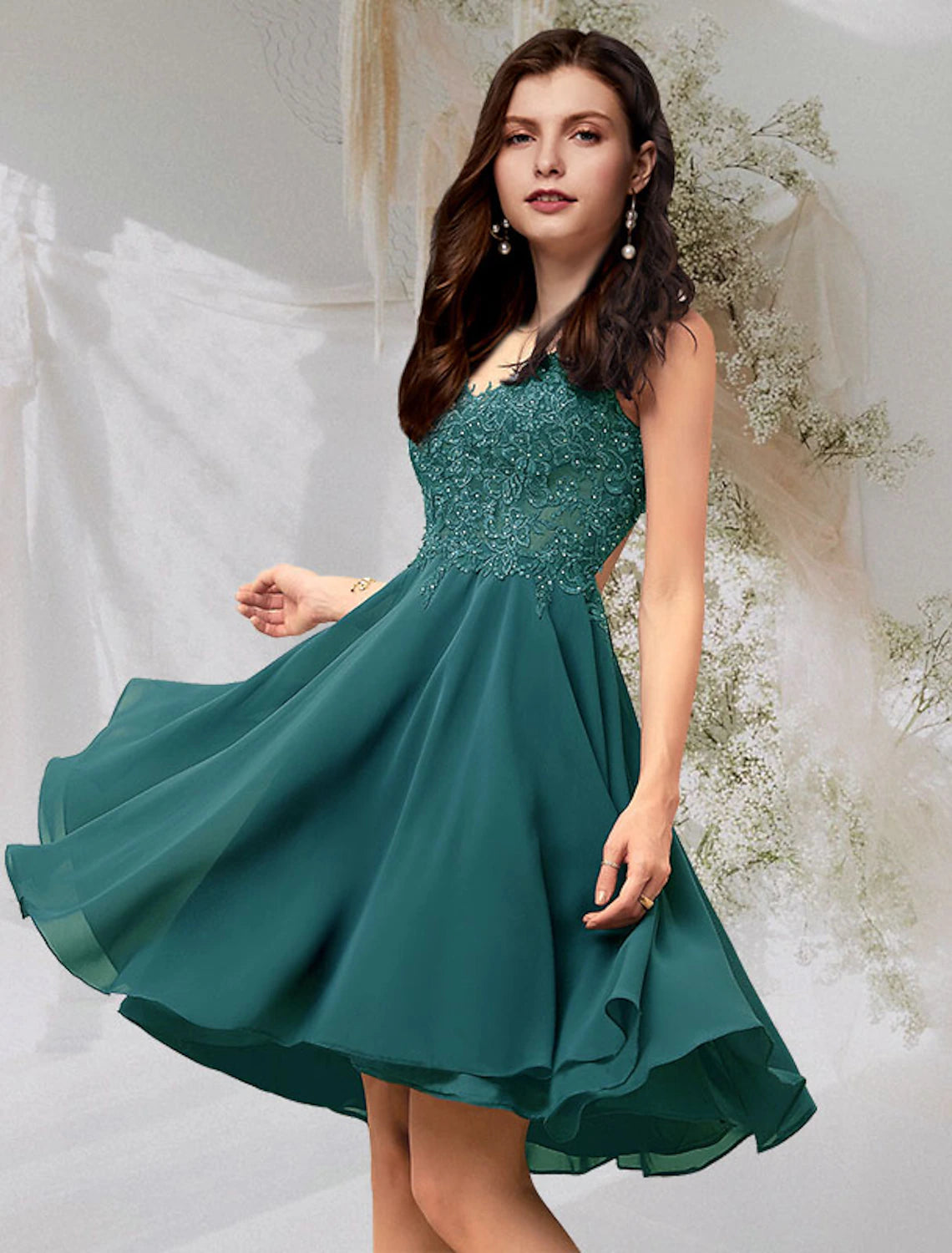 Woman wearing an A-line V-neck chiffon cocktail dress with beading and lace.