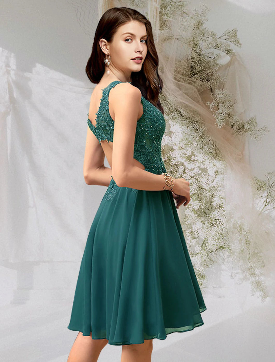 Back view of an A-line V-neck chiffon cocktail dress with backless design and lace details.