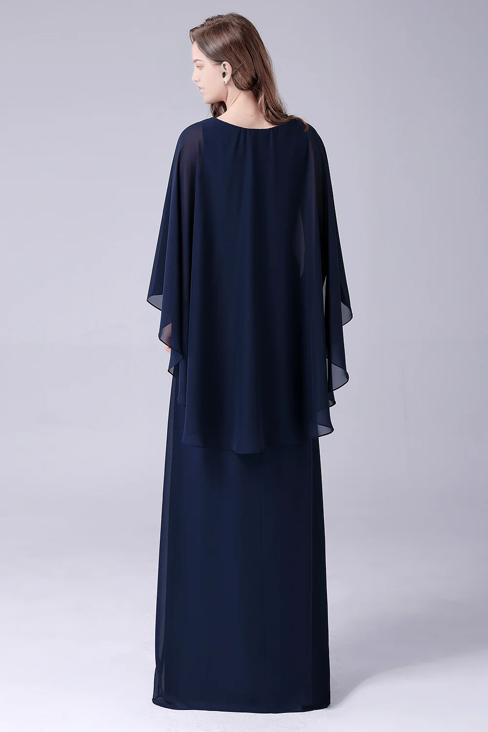 Woman wearing an A-Line V-Neck chiffon gown, side profile.