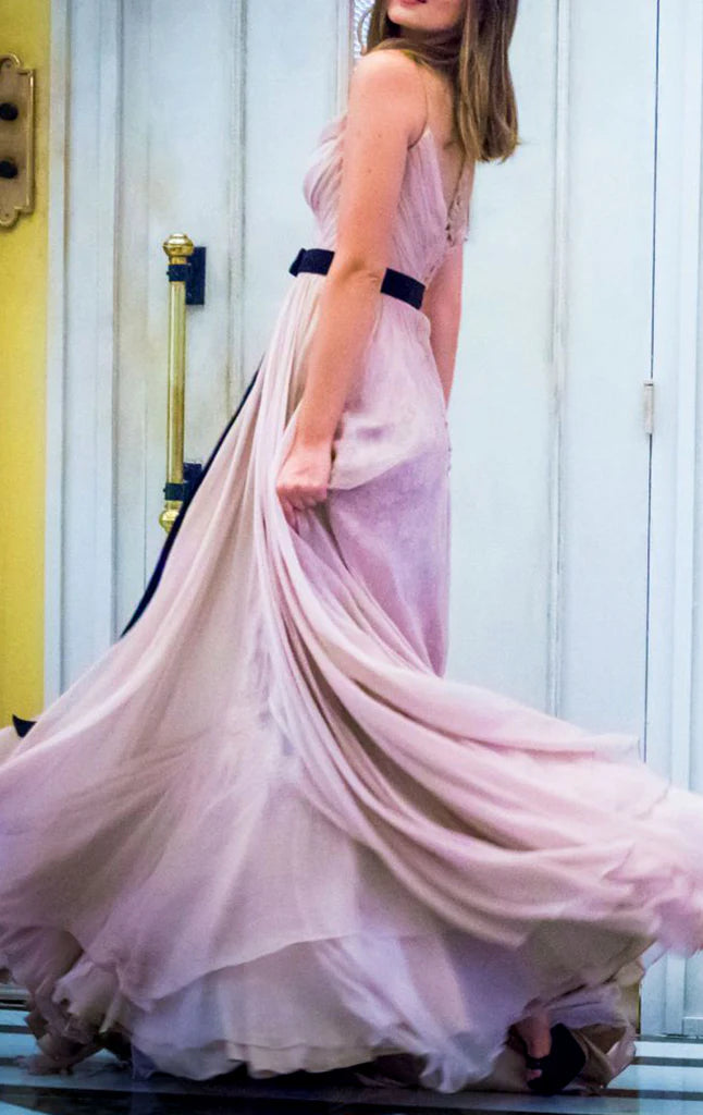 Model showcasing a flowing V-neck chiffon prom dress with a graceful silhouette.