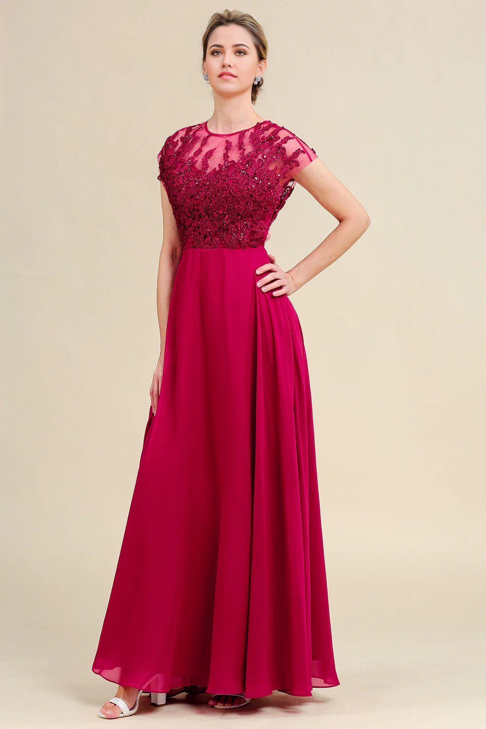 Close-up of the V-neckline and delicate lace on the chiffon mother of the bride dress.
