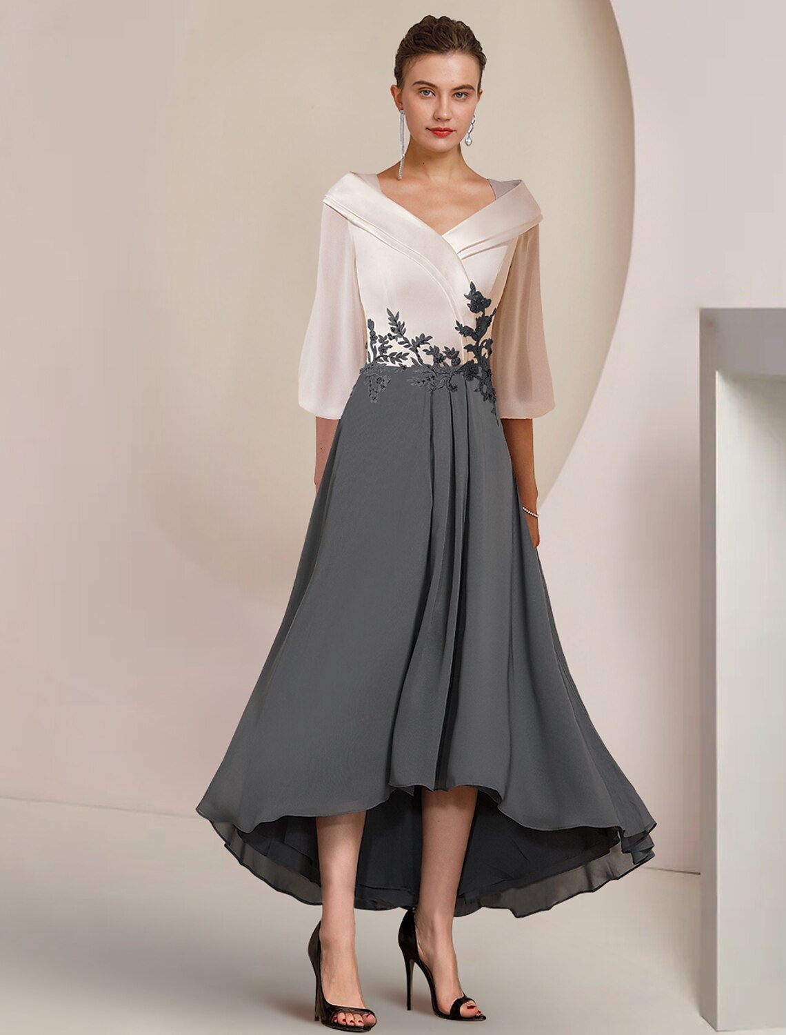 Elegant A-line mother of the bride dress with V-neck and 3/4 sleeves, featuring a high-low tea length hem.