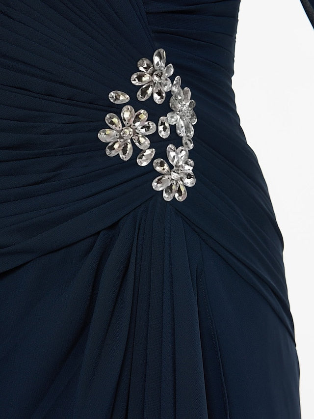 Close-up of delicate beading and sash detail on chiffon dress.