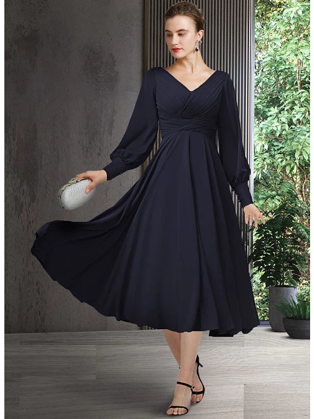 Elegant A-line V-neck chiffon tea length dress with pleats and ruching.
