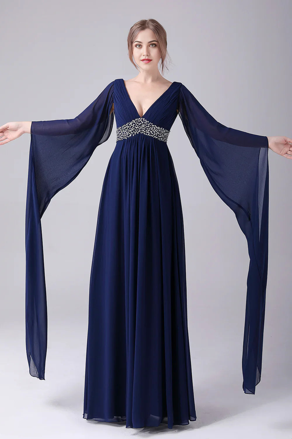Side view of a V-neck floor-length chiffon dress with pleated details.
