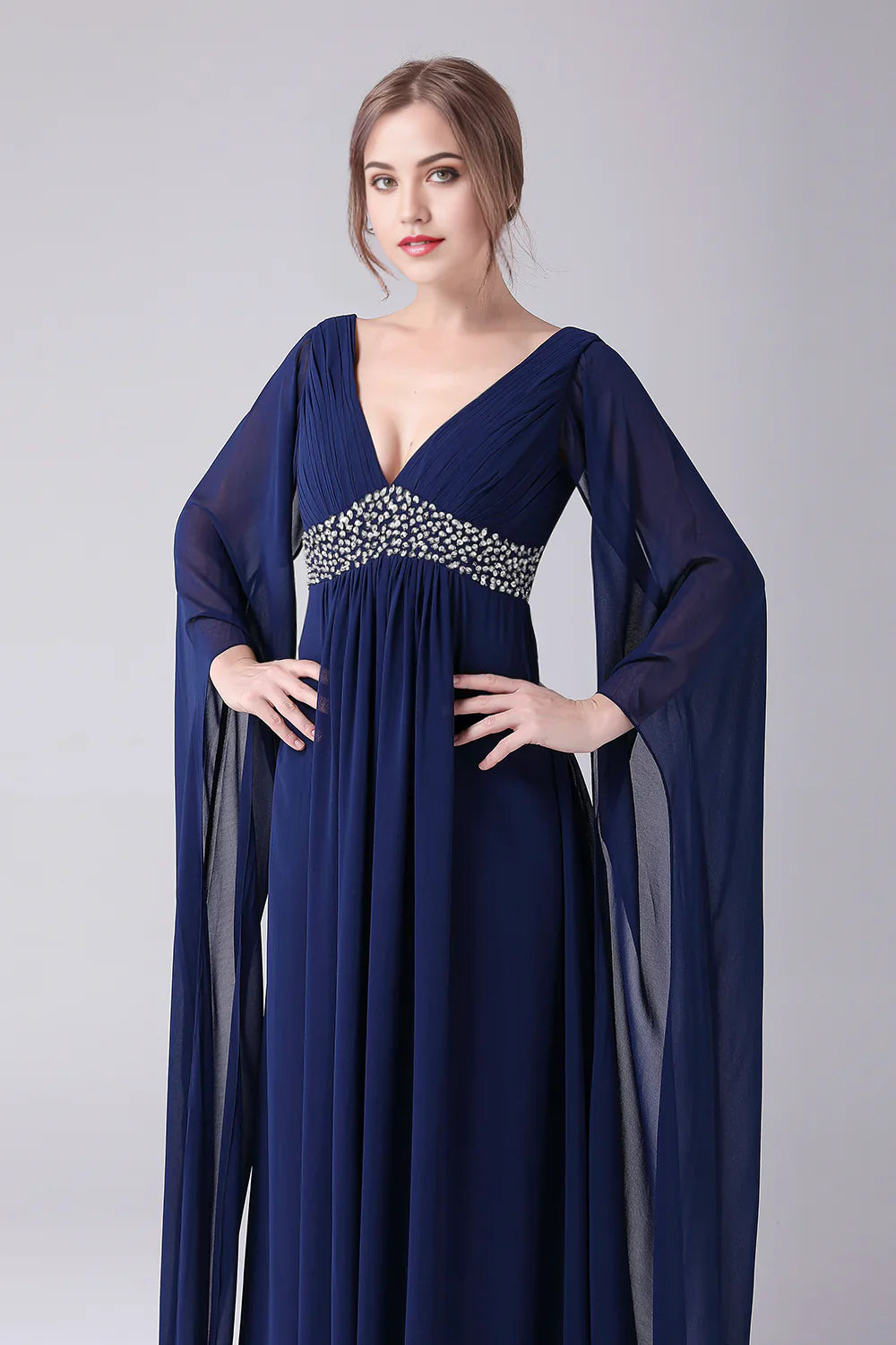 Close-up of the pleated bodice and V-neckline of a formal chiffon gown.