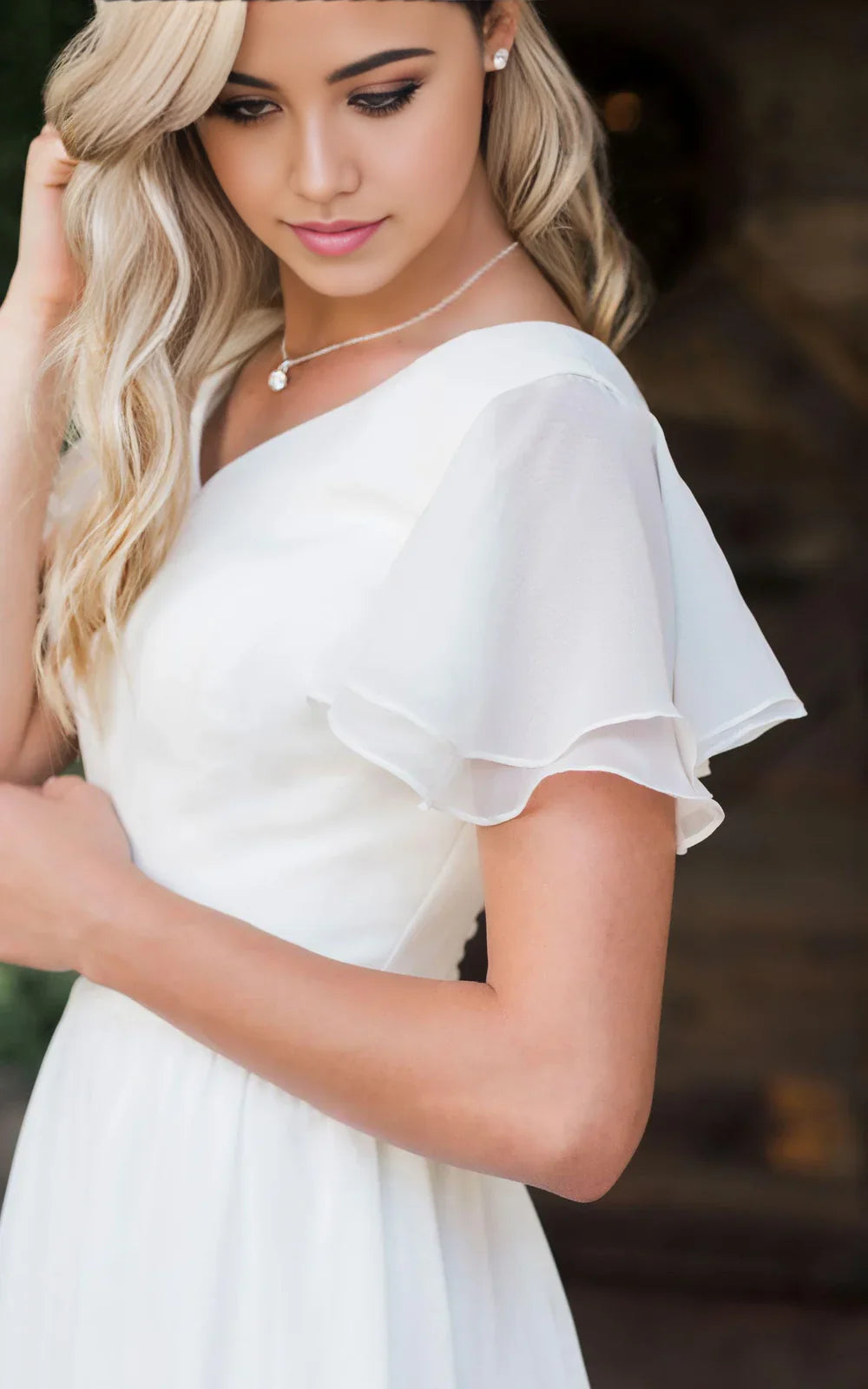 Side view of A-line V-neck bridal gown with short sleeves.